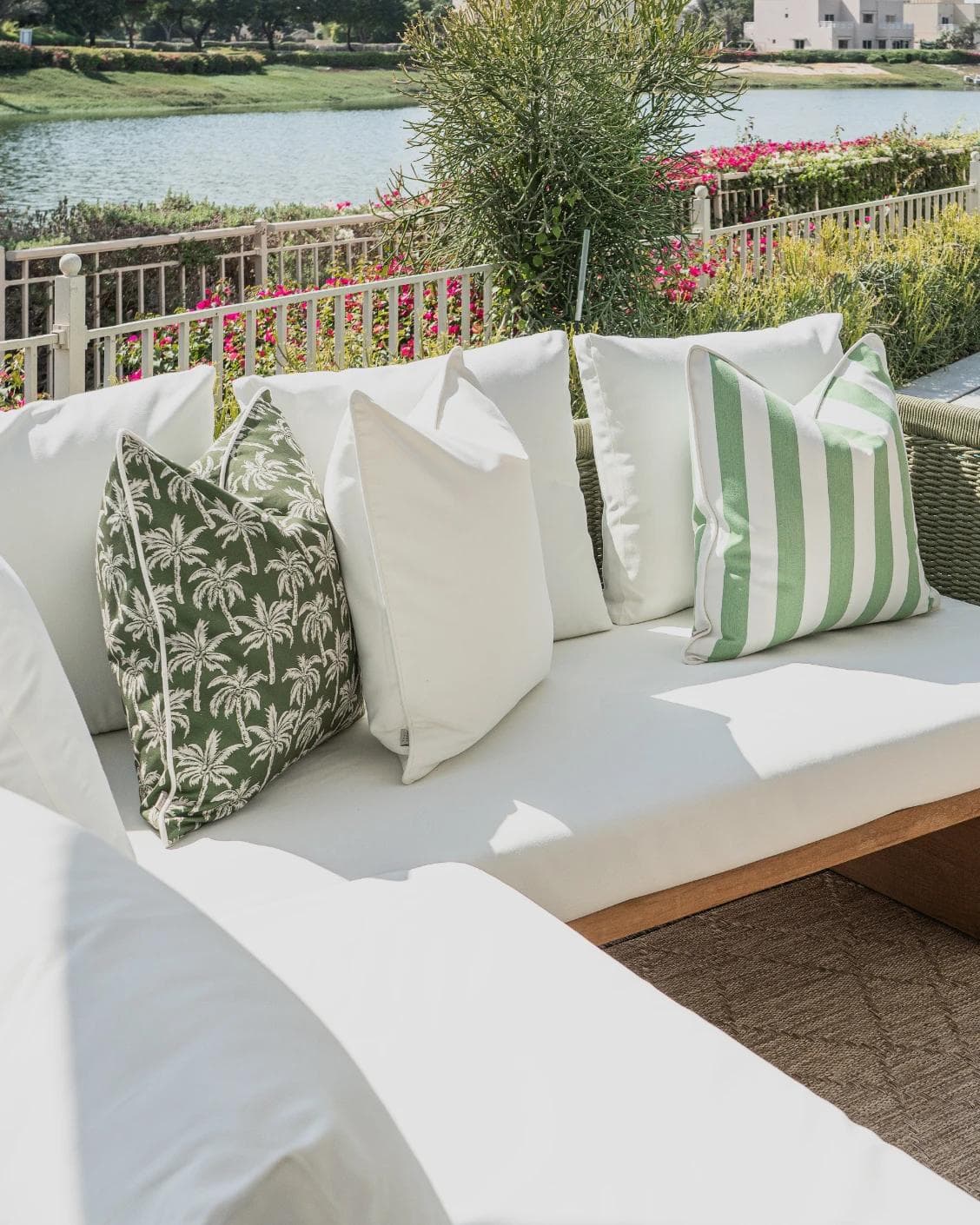 Arina Bundle cushion in green and ivory, shown in a lifestyle left view as image 2