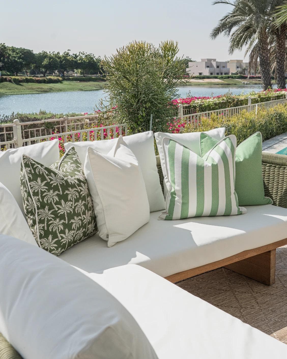 Arsh Bundle cushion in green and ivory, shown in a lifestyle left view as image 2