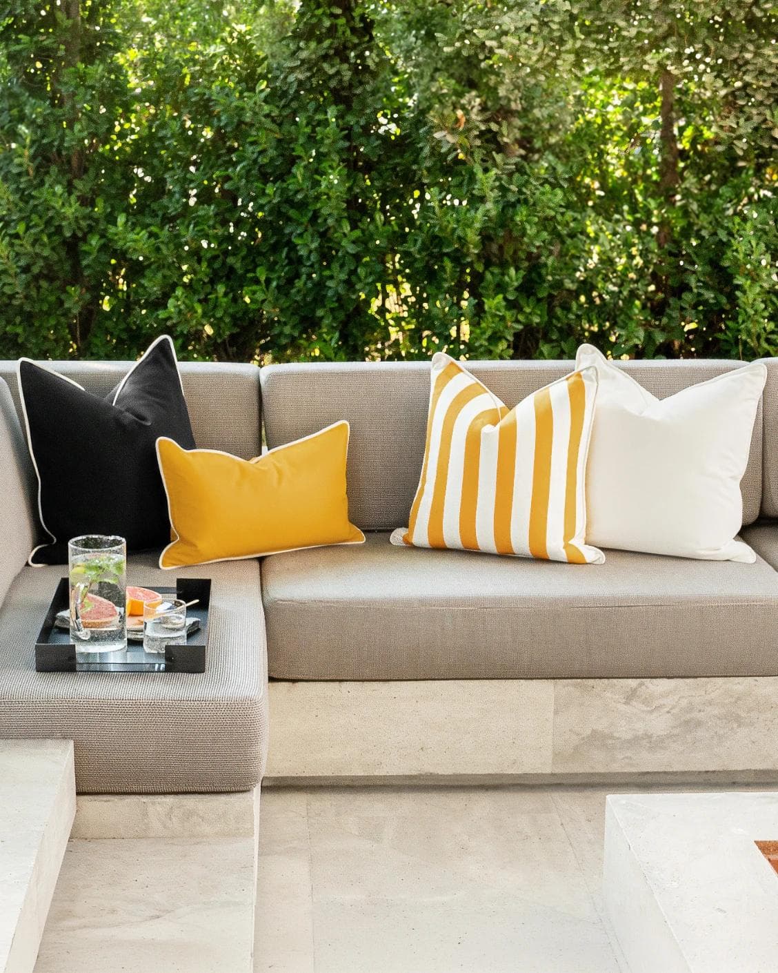 Arun Bundle cushion in yellow, ivory and black, shown in a lifestyle front view as image 4