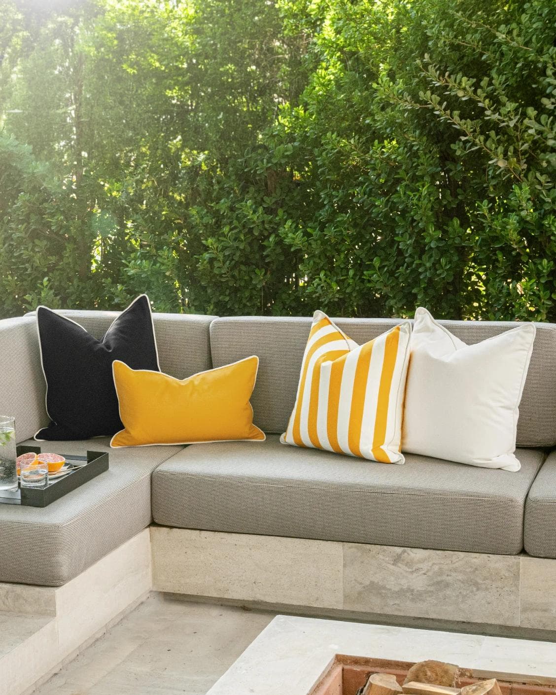 Arun Bundle cushion in yellow, ivory and black, shown in a lifestyle front view as image 2