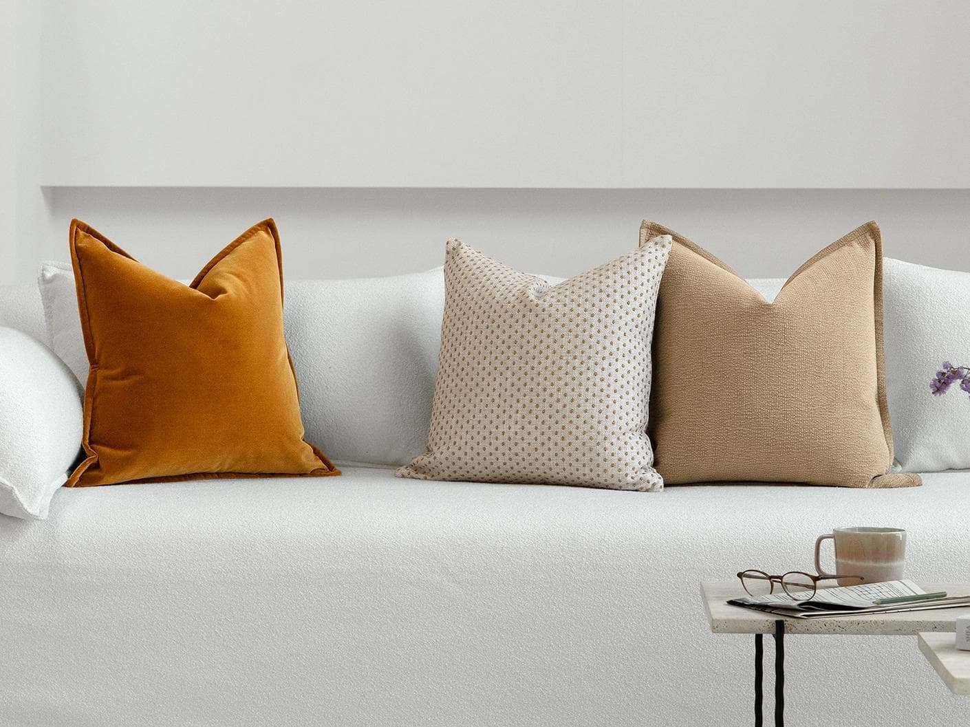 Astra Bundle cushion in beige, brown and orange, shown in a lifestyle front view as image 4