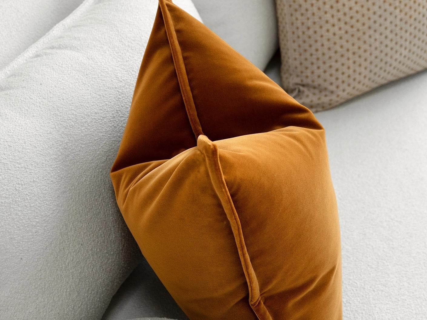 Astra Bundle cushion in beige, brown and orange, shown in a lifestyle left view as image 6