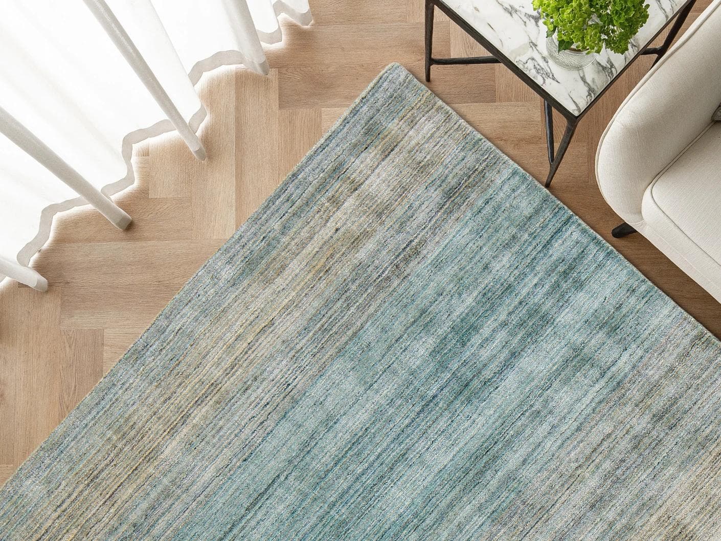 Ava Sandy carpets in turquoise and beige, shown in a lifestyle top view as image 3