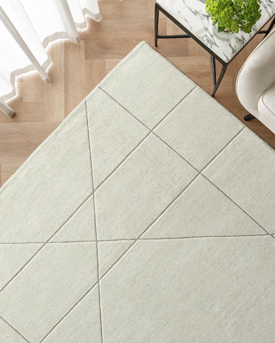 Axis Bianca carpet in beige, shown in a lifestyle top view as image 2