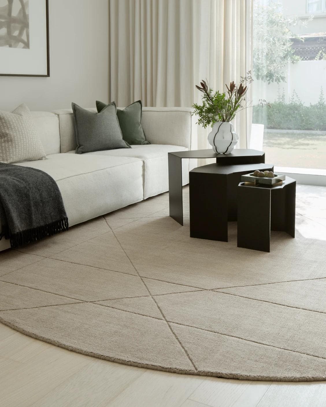 Axis Oat Round carpet in beige and brown, shown in a lifestyle left view as image 4