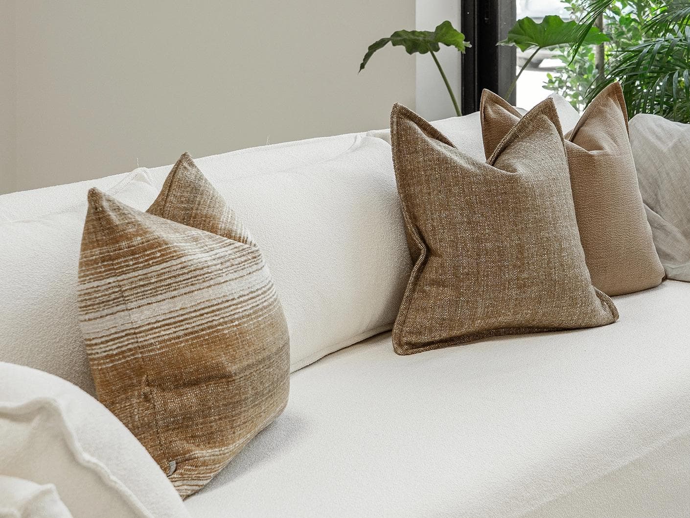 Aya Bundle cushion in brown, shown in a lifestyle left view as image 2
