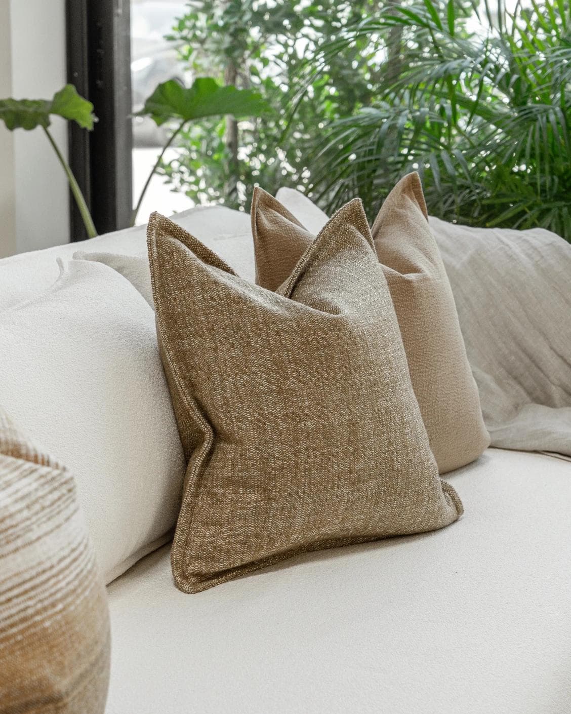 Aya Bundle cushion in brown, shown in a lifestyle left view as image 5
