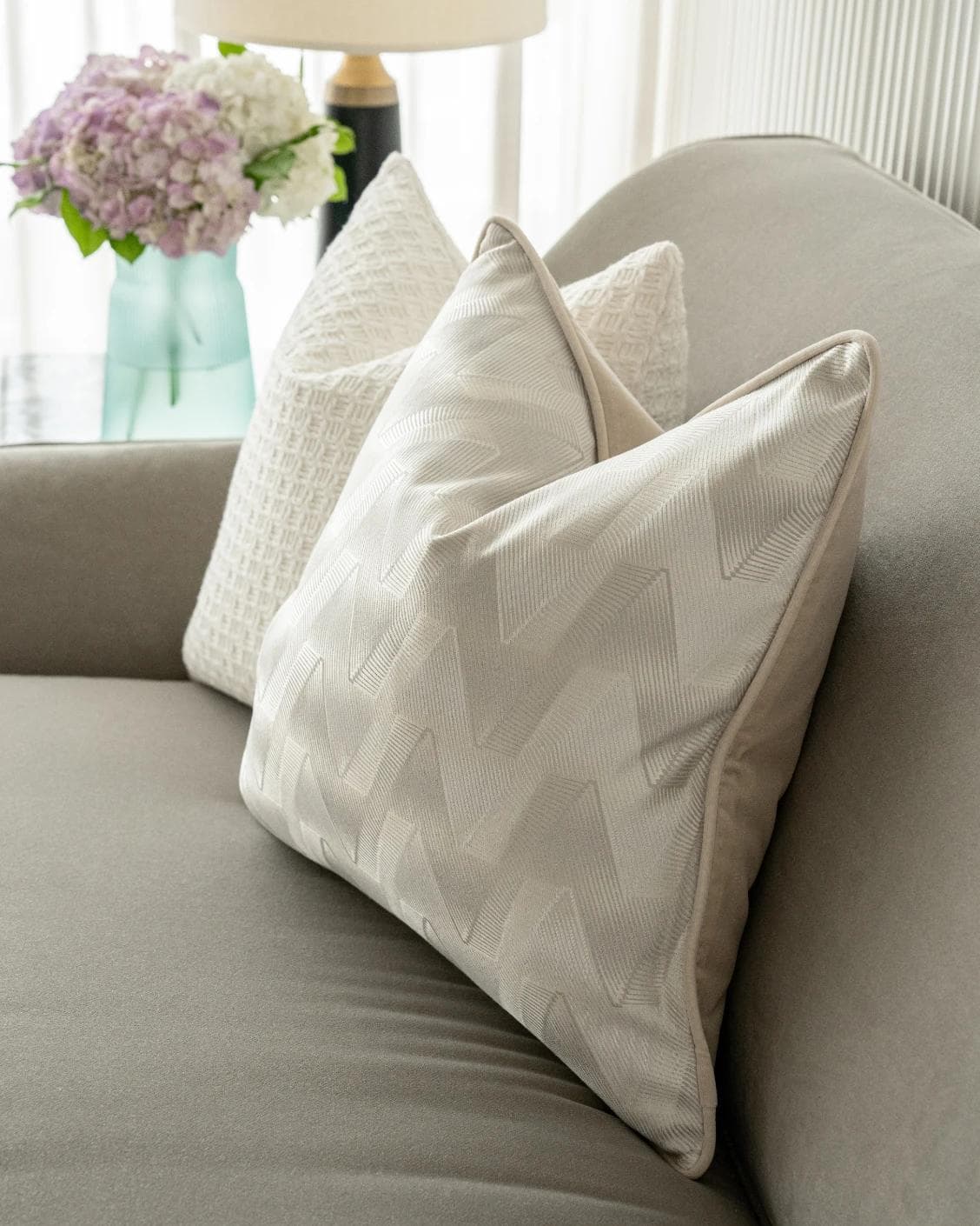 Aynura Bundle cushion in white, beige and silver, shown in a lifestyle front view as image 4