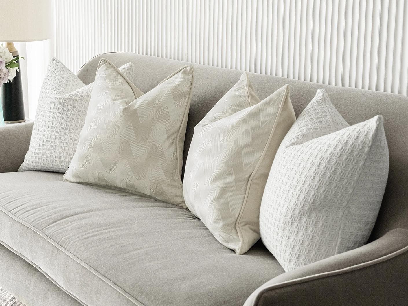 Aynura Bundle cushion in white, beige and silver, shown in a lifestyle right view as image 6