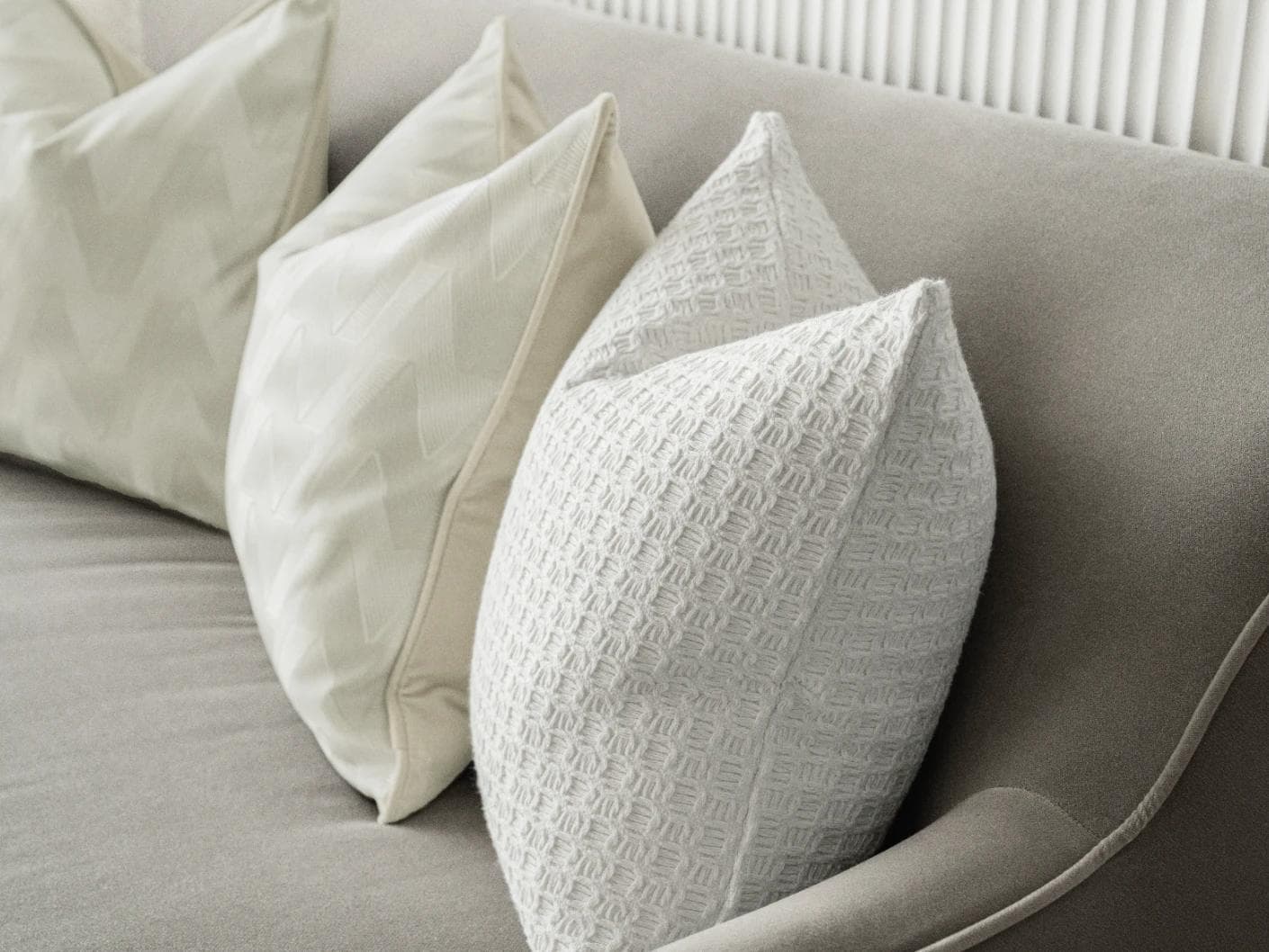 Aynura Bundle cushion in white, beige and silver, shown in a lifestyle right view as image 7