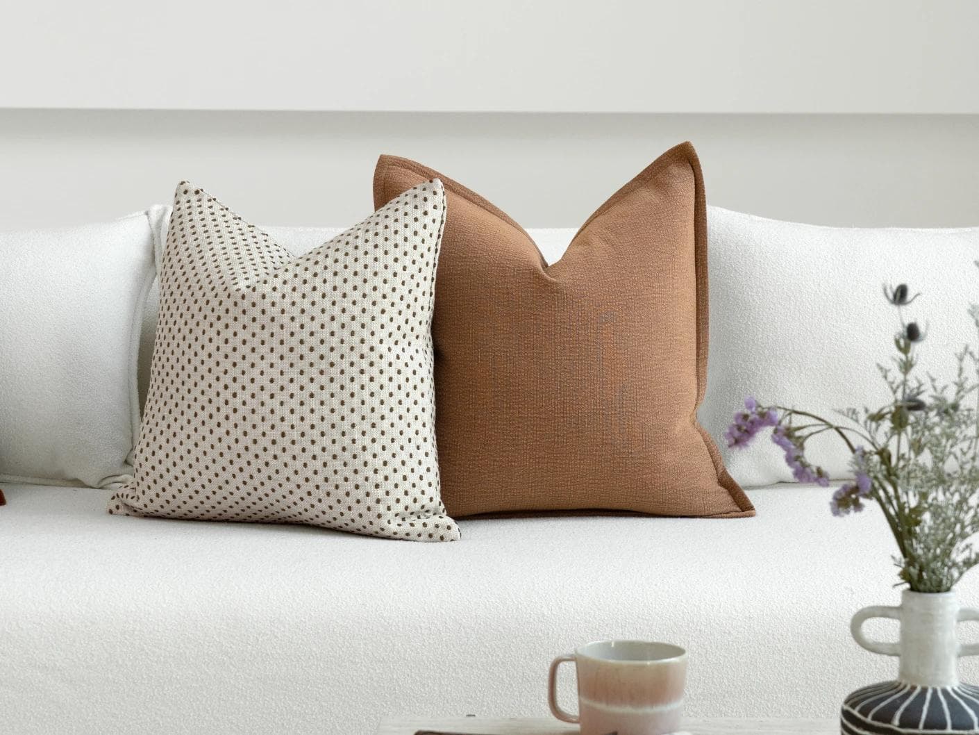 Azar Bundle cushion in beige and rust, shown in a lifestyle front view as image 5