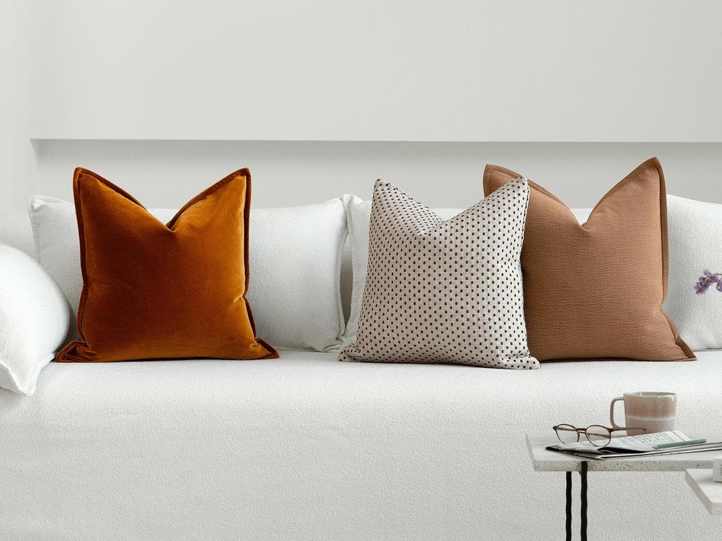 Azar Bundle cushion in beige and rust, shown in a lifestyle right view as image 2