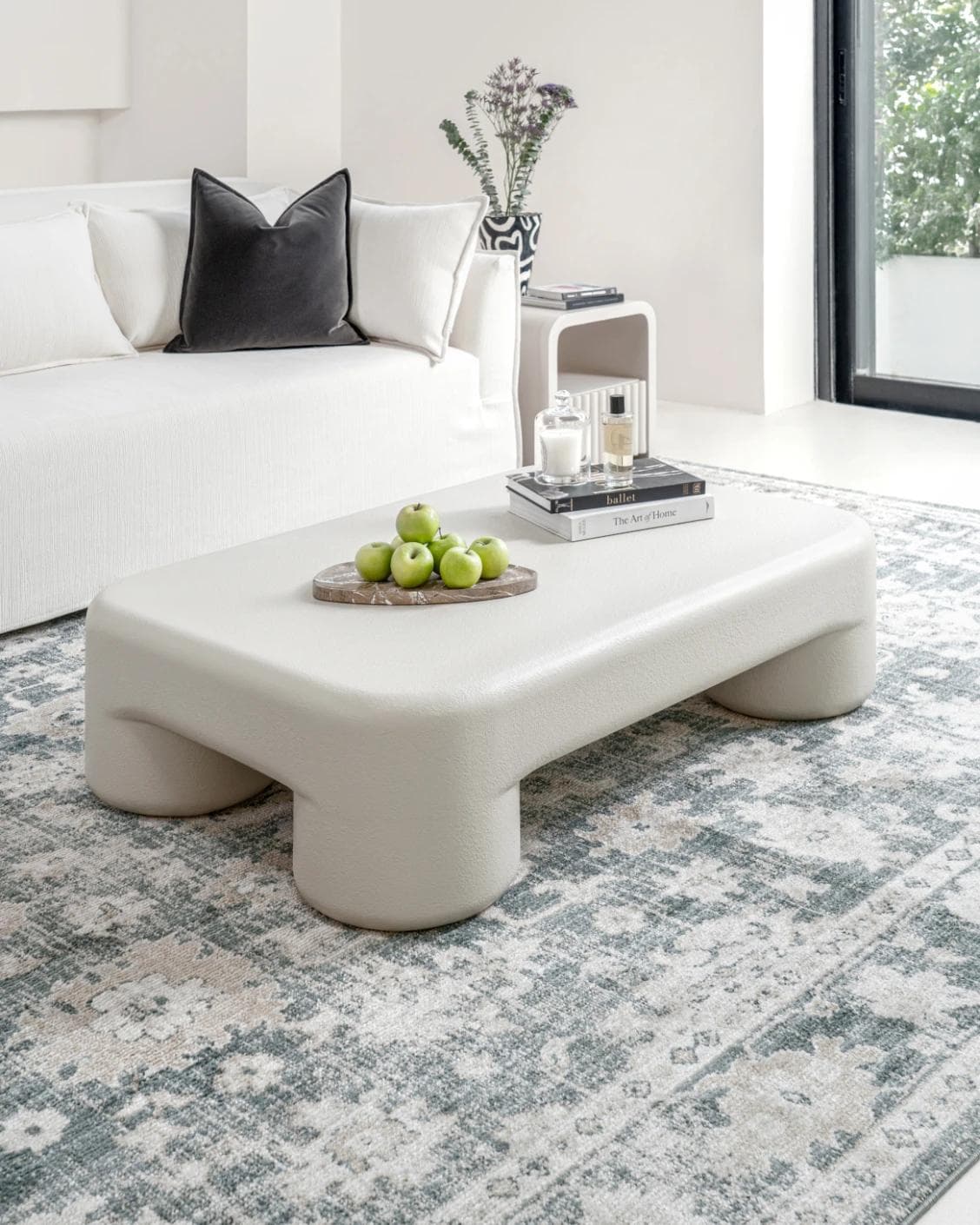 Bari coffee table in soft ivory and stone, shown in a lifestyle left view as image 2