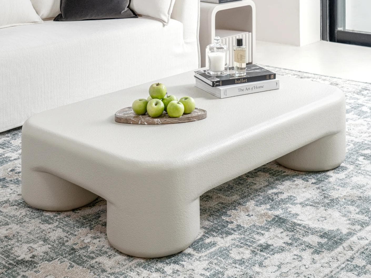 Bari coffee table in soft ivory and stone, shown in a lifestyle left view as image 2