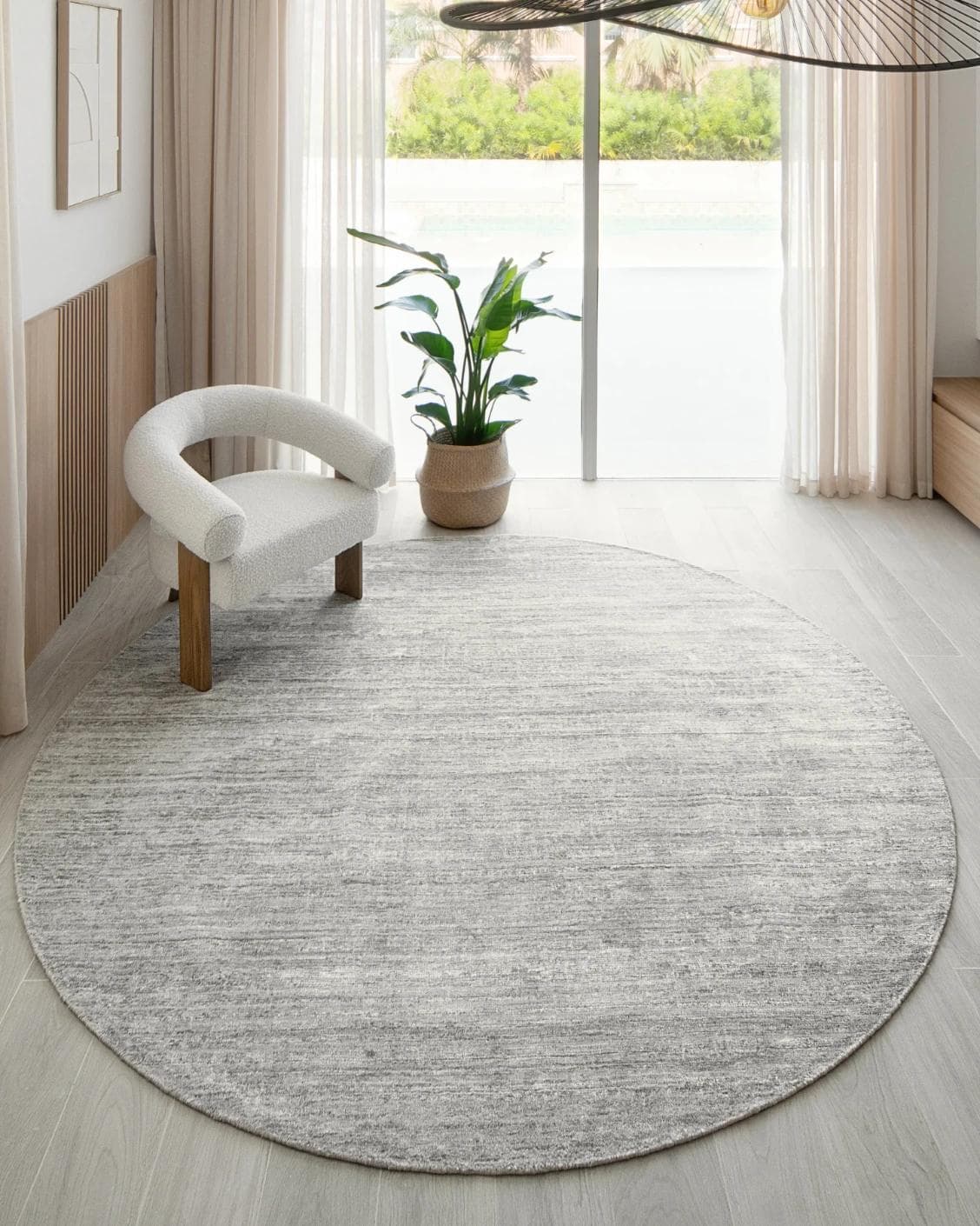 Beatrice Dune 02 Round carpet in grey, shown in a lifestyle front view