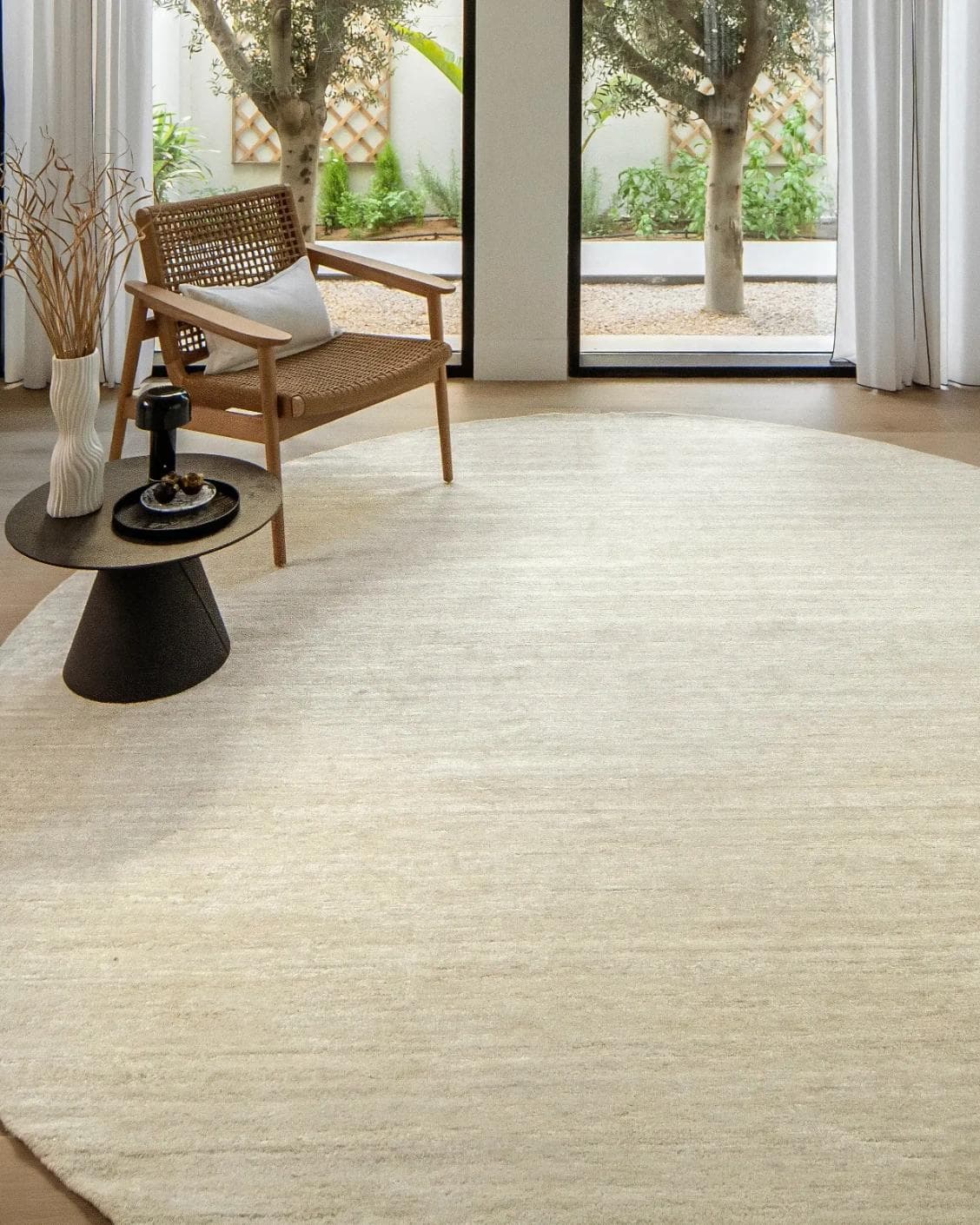 Beatrice Sandy 02 Round carpet in beige, shown in a lifestyle front view