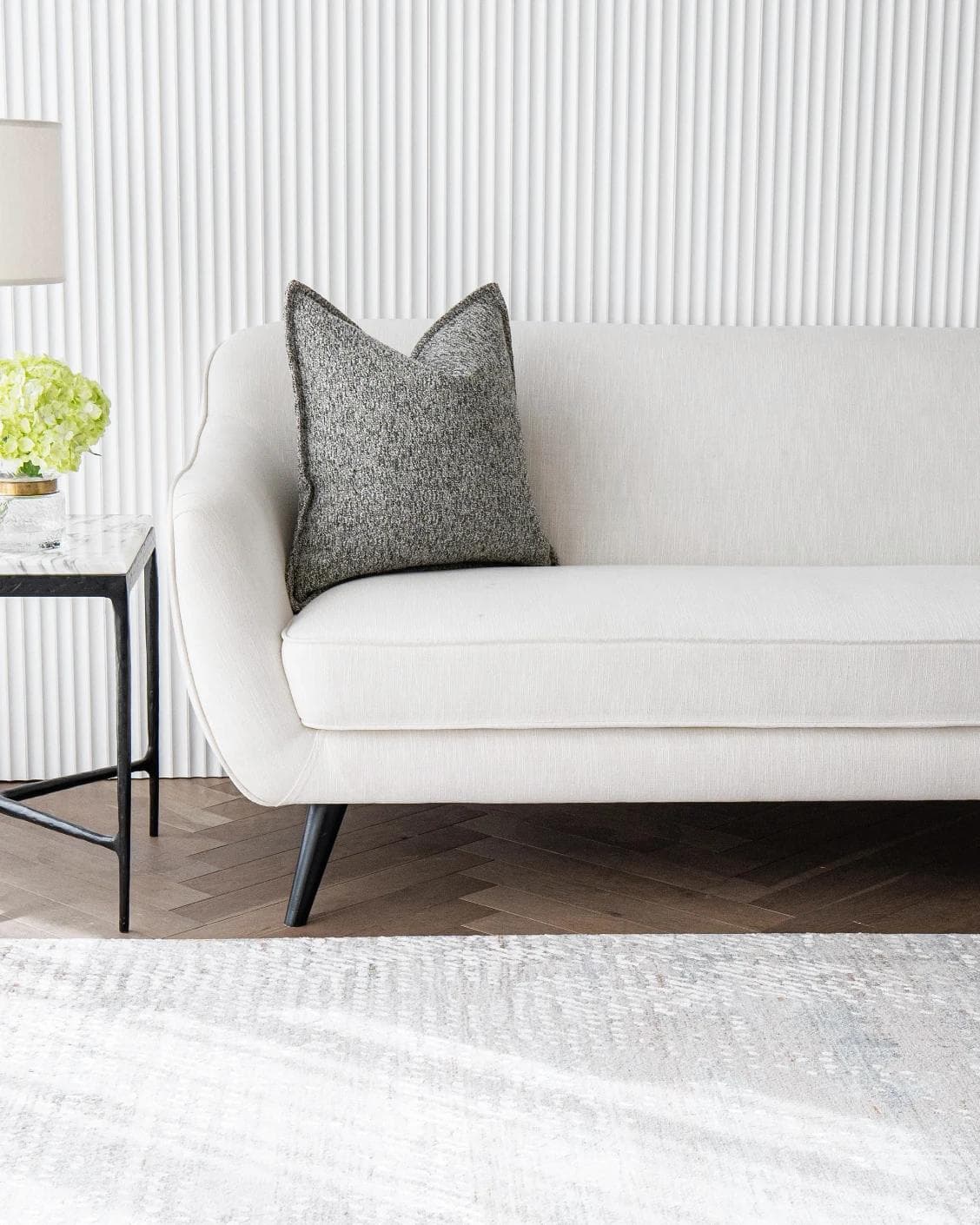 Bennett Steele cushion in silver and grey, shown in a lifestyle front view as image 4