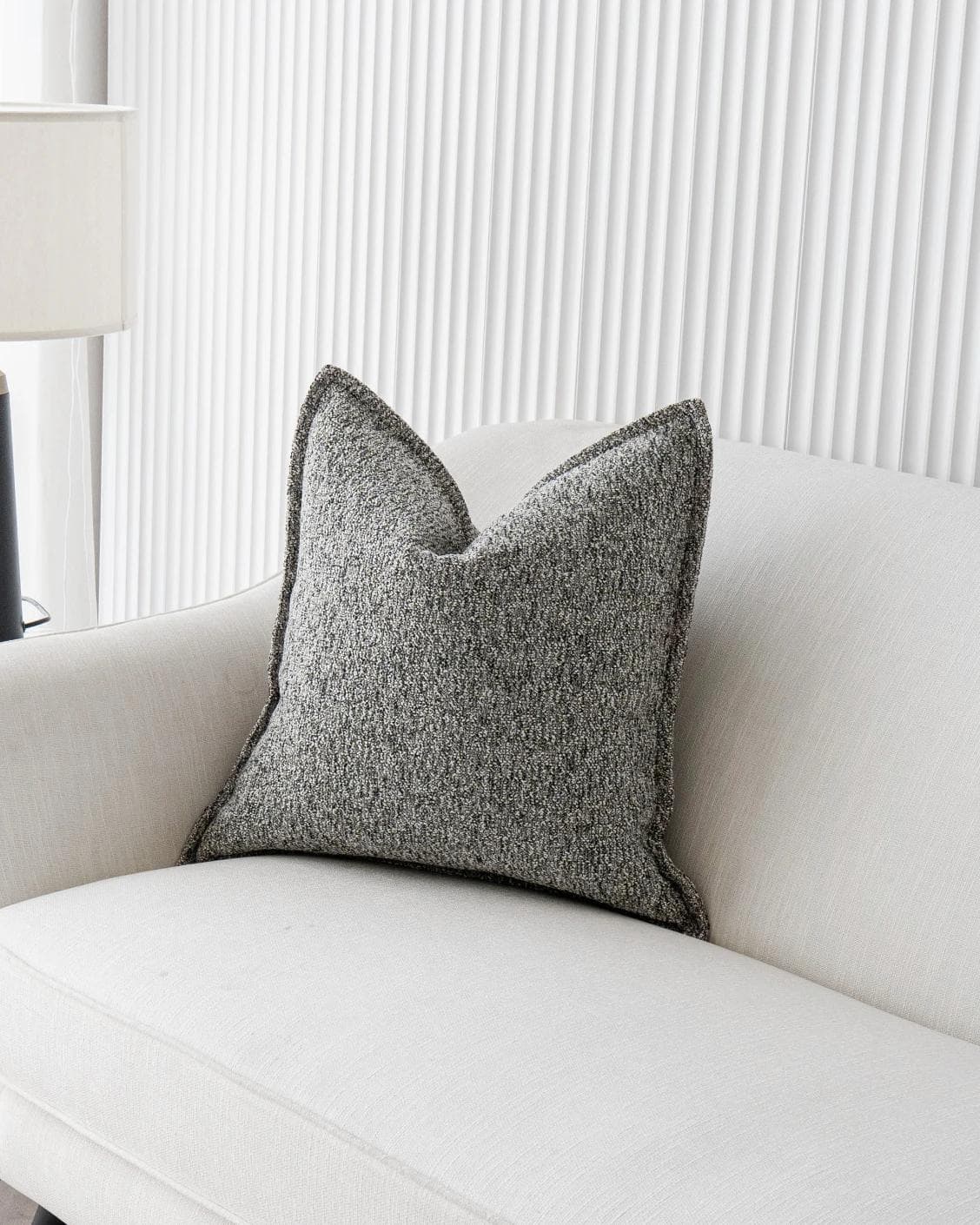 Bennett Steele cushion in silver and grey, shown in a lifestyle right view as image 2
