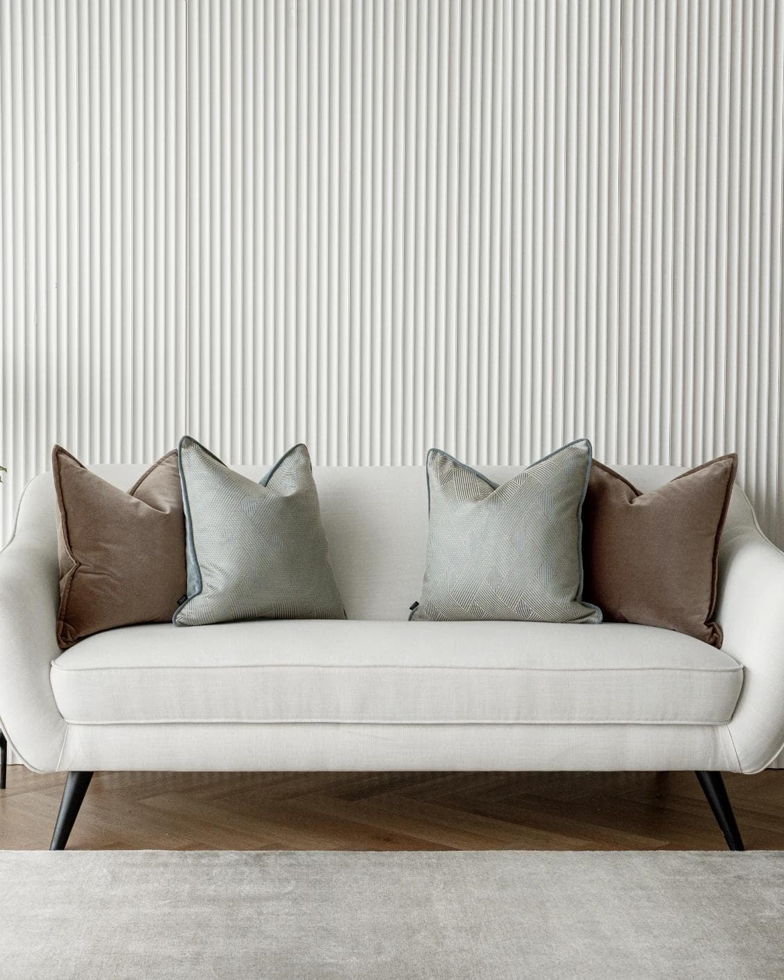 Bernie Bundle cushion in brown and blue, shown in a lifestyle front view as image 4