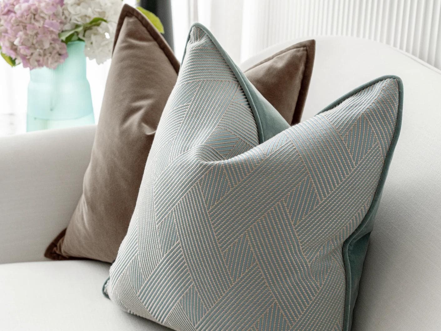 Bernie Bundle cushion in brown and blue, shown in a lifestyle right view as image 6