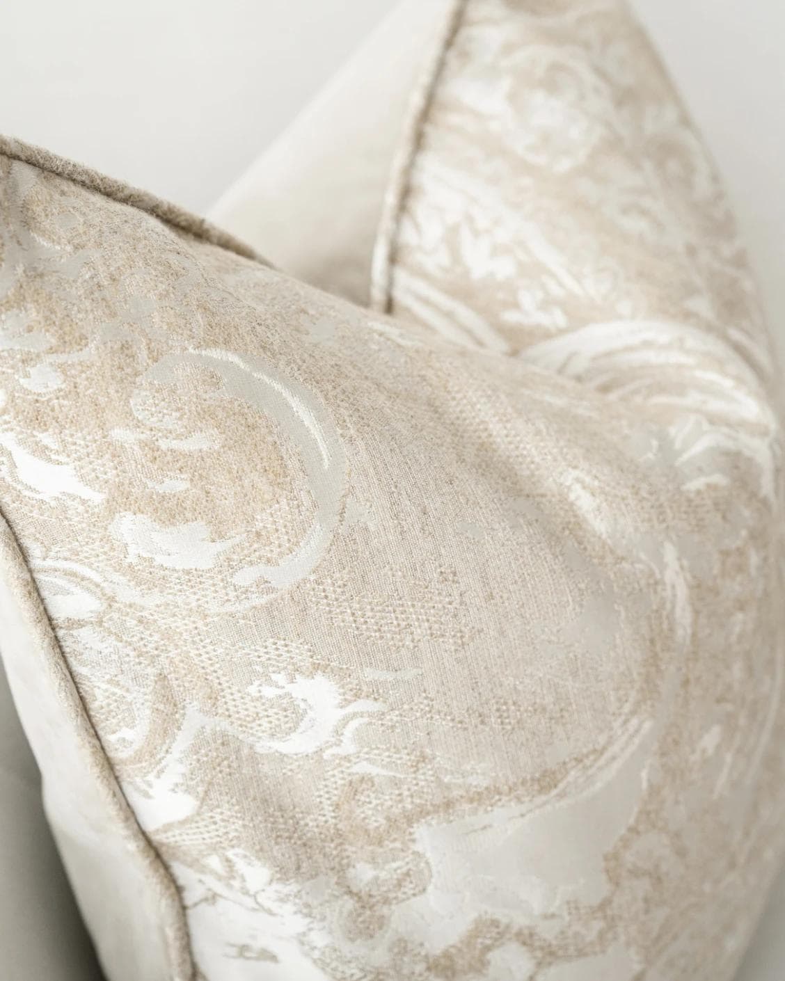 Berti Hodler cushion in beige and silver, shown in a lifestyle left view as image 5
