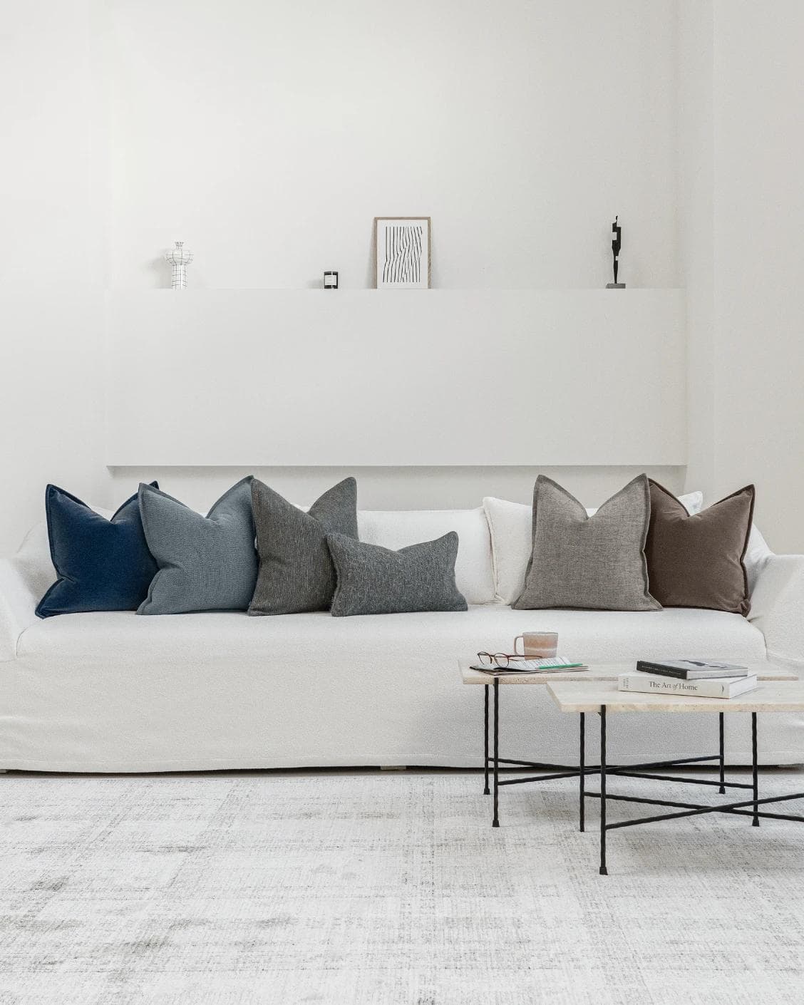 Bracia Bundle cushion in brown, grey and blue, shown in a lifestyle front view as image 4