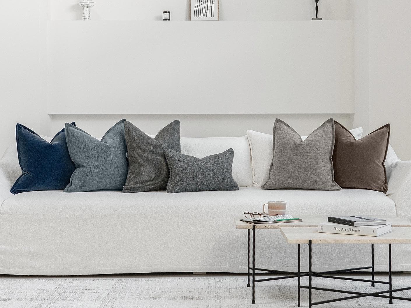 Bracia Bundle cushion in brown, grey and blue, shown in a lifestyle front view as image 4