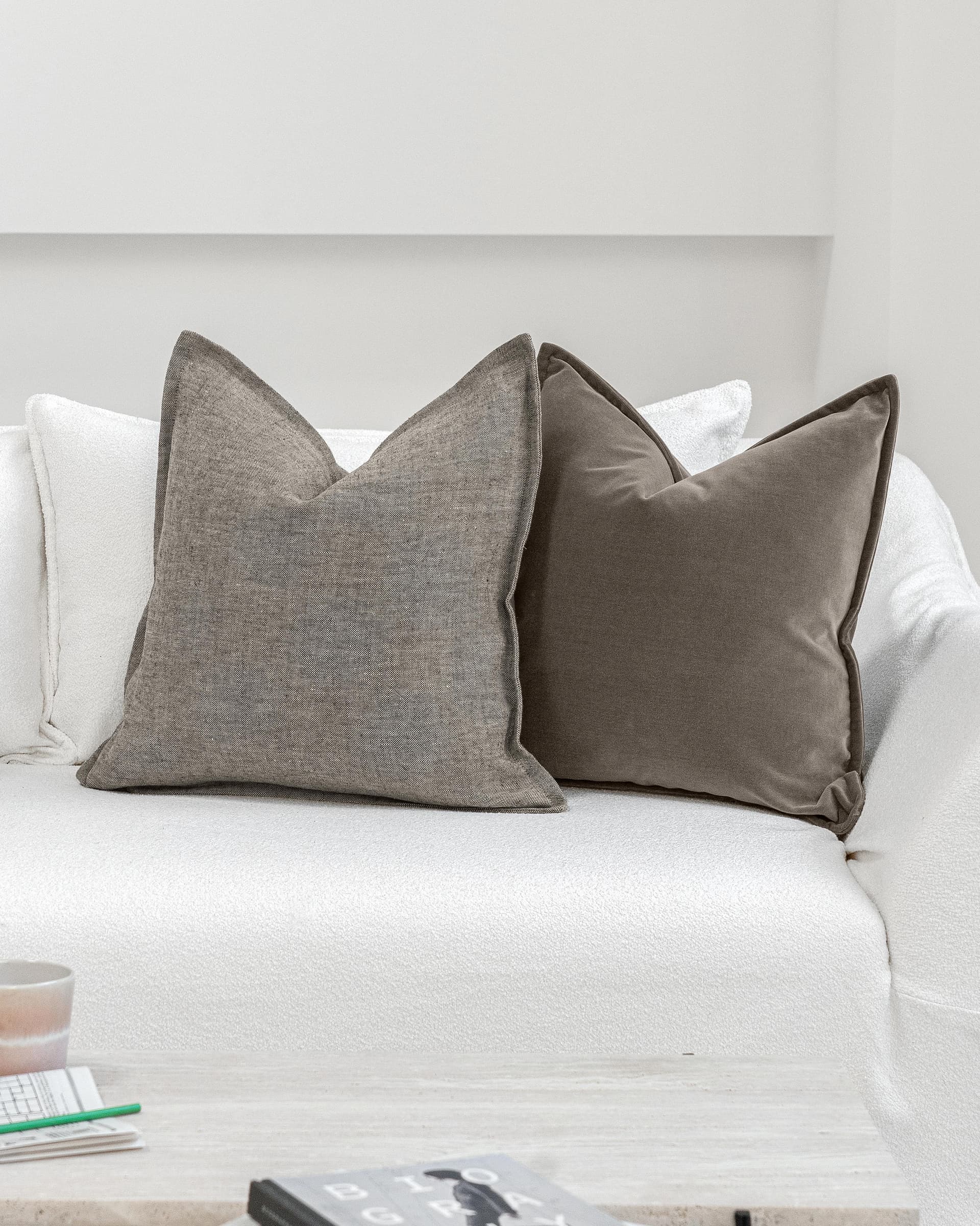 Bracia Bundle cushion in brown, grey and blue, shown in a lifestyle front view as image 5