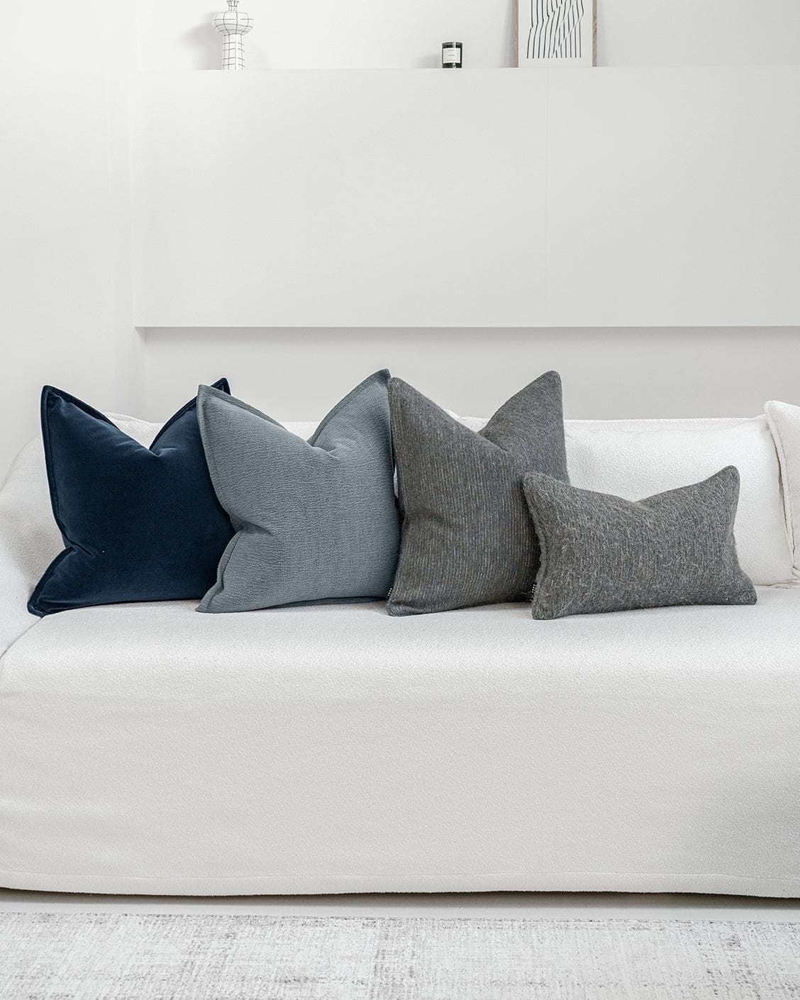 Bracia Bundle cushion in brown, grey and blue, shown in a product front view as image 6