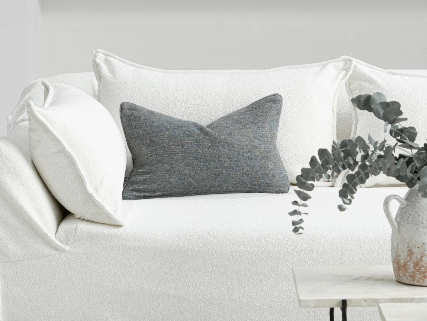 Bree Canova II cushion in grey and blue, shown in a lifestyle front view as image 4
