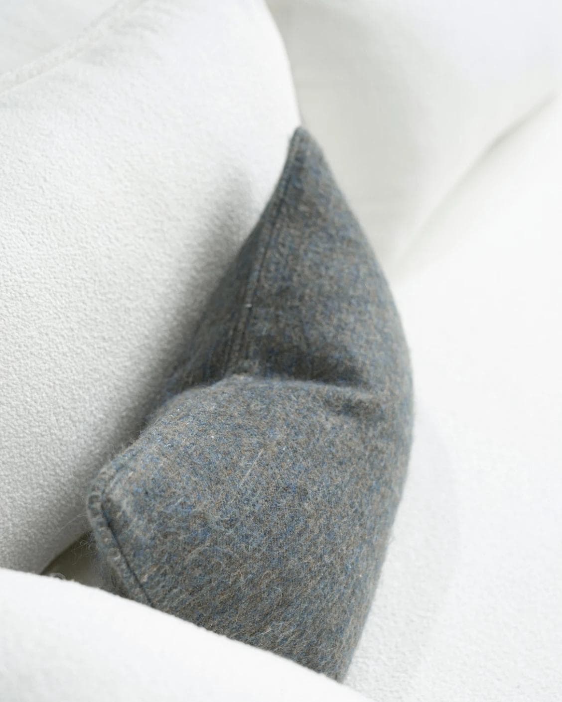 Bree Canova II cushion in grey and blue, shown in a lifestyle top view as image 5