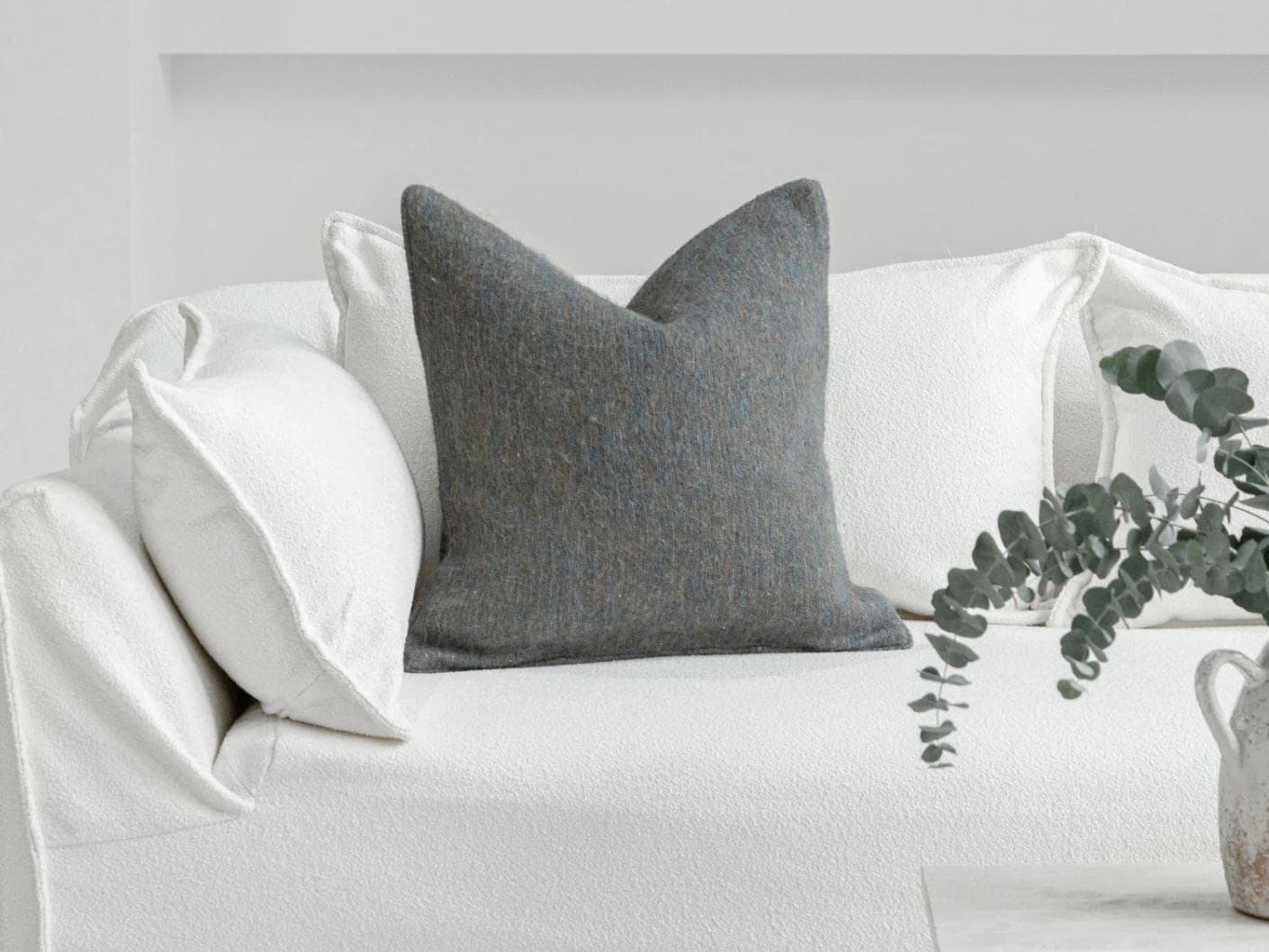 Bree Canova cushion in blue and grey, shown in a lifestyle front view as image 4