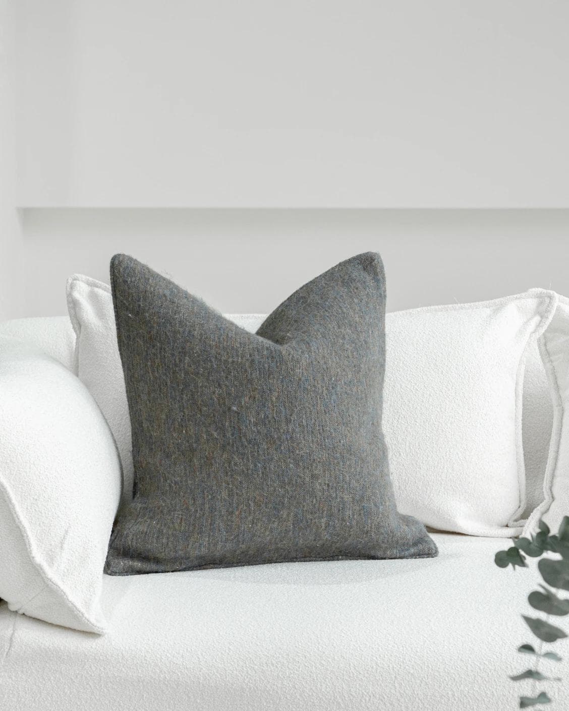 Bree Canova cushion in blue and grey, shown in a lifestyle front view as image 2