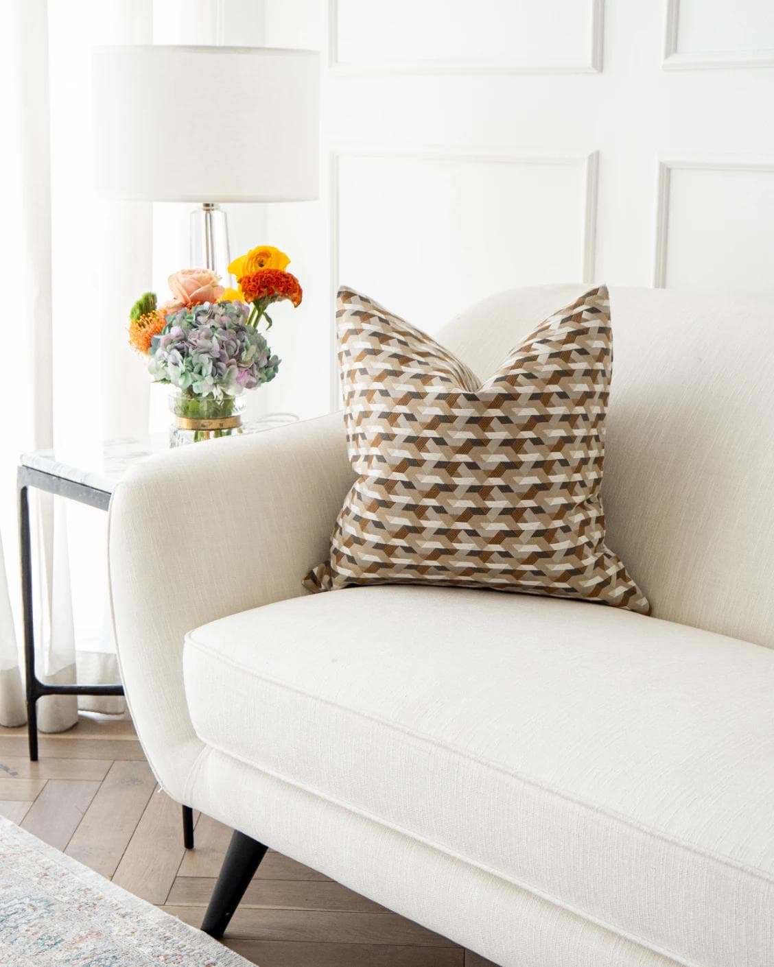 Brianna Laurent cushion in orange and beige, shown in a lifestyle front view as image 5