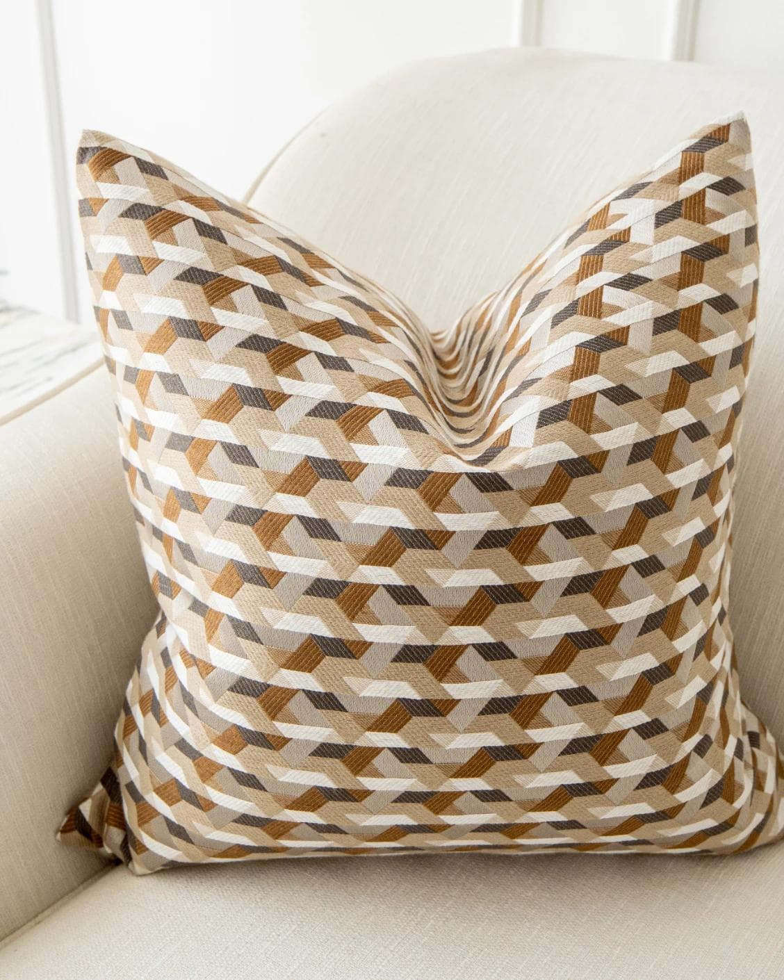 Brianna Laurent cushion in orange and beige, shown in a lifestyle top view as image 6