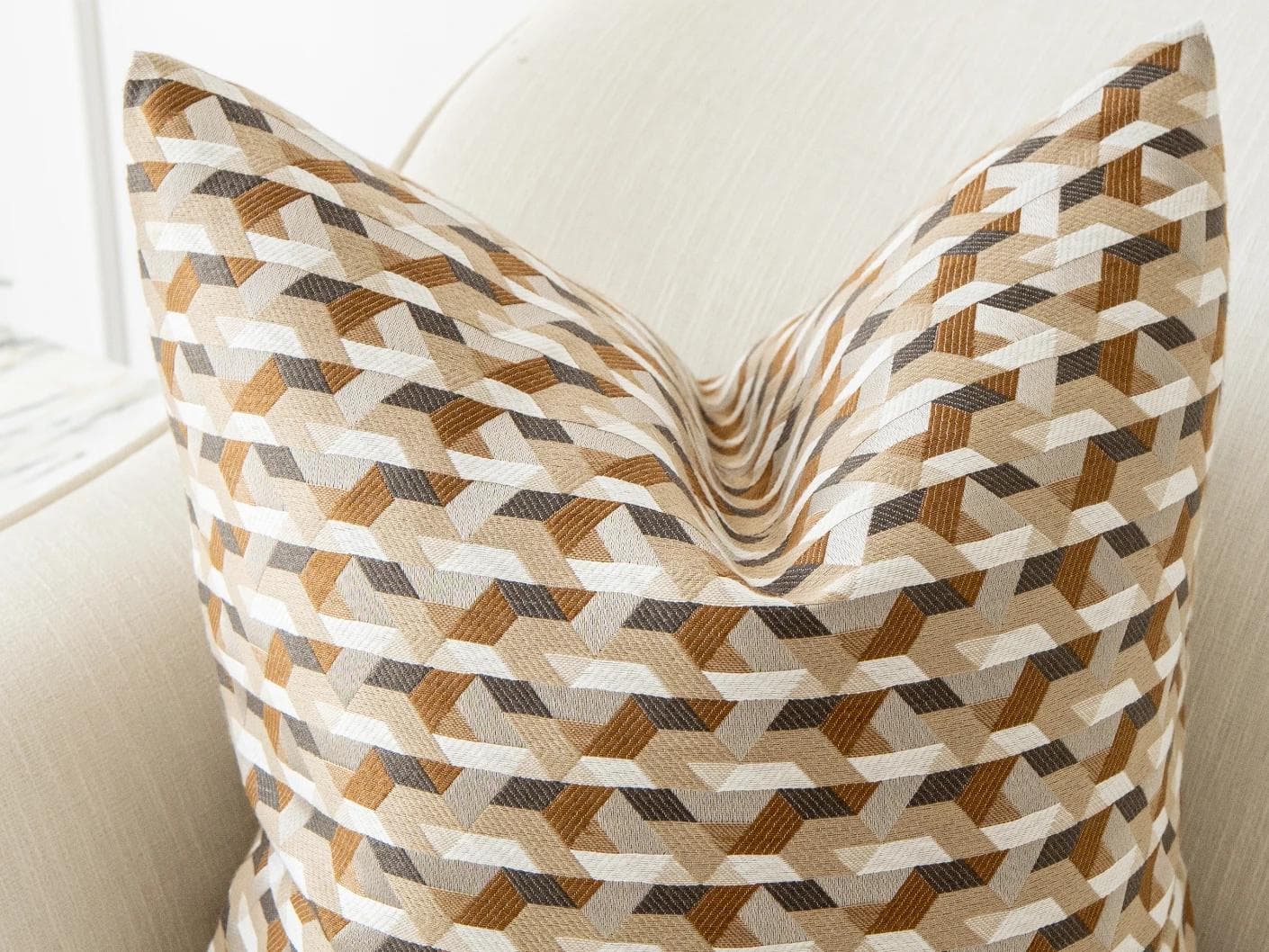Brianna Laurent cushion in orange and beige, shown in a lifestyle top view as image 6
