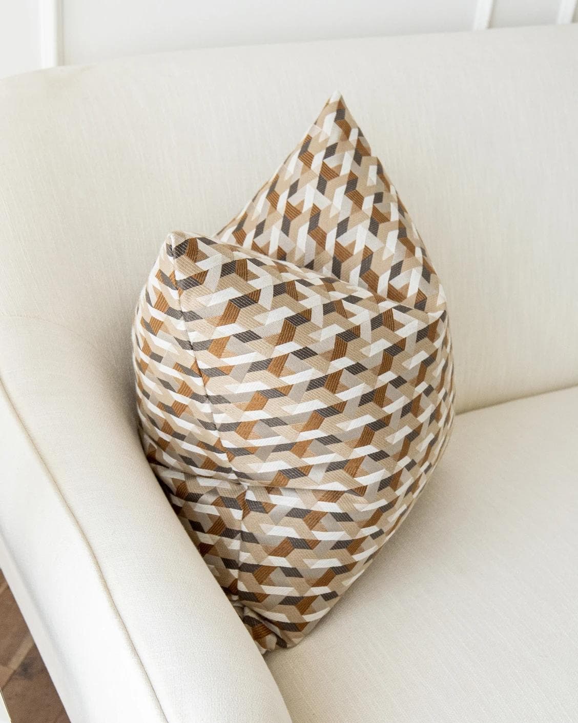 Brianna Laurent cushion in orange and beige, shown in a lifestyle top view as image 7