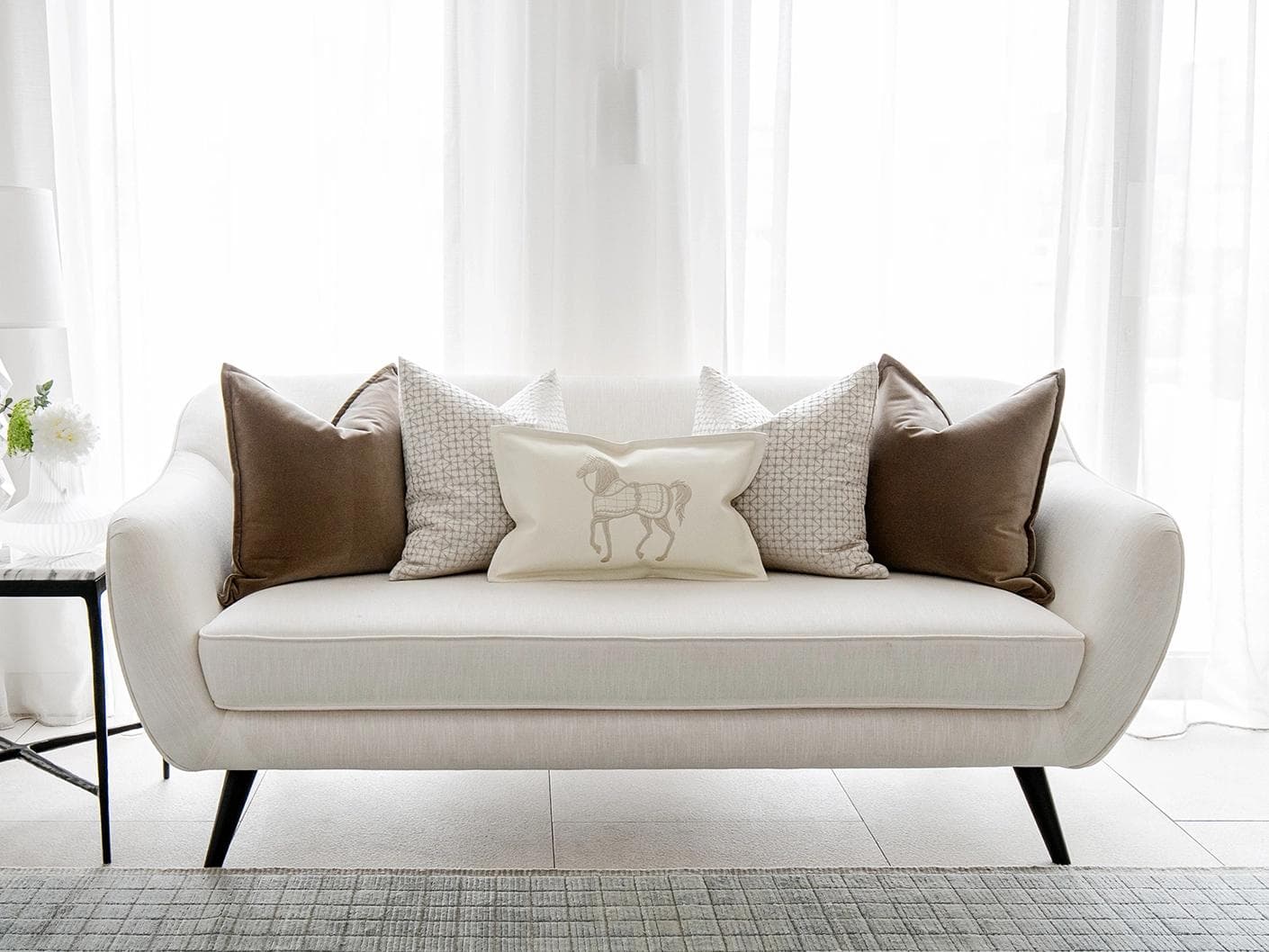 Lina Bundle cushion in brown, silver and white, shown in a lifestyle front view as image 4