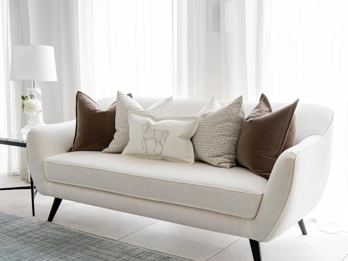 Lina Bundle cushion in brown, silver and white, shown in a lifestyle right view as image 2