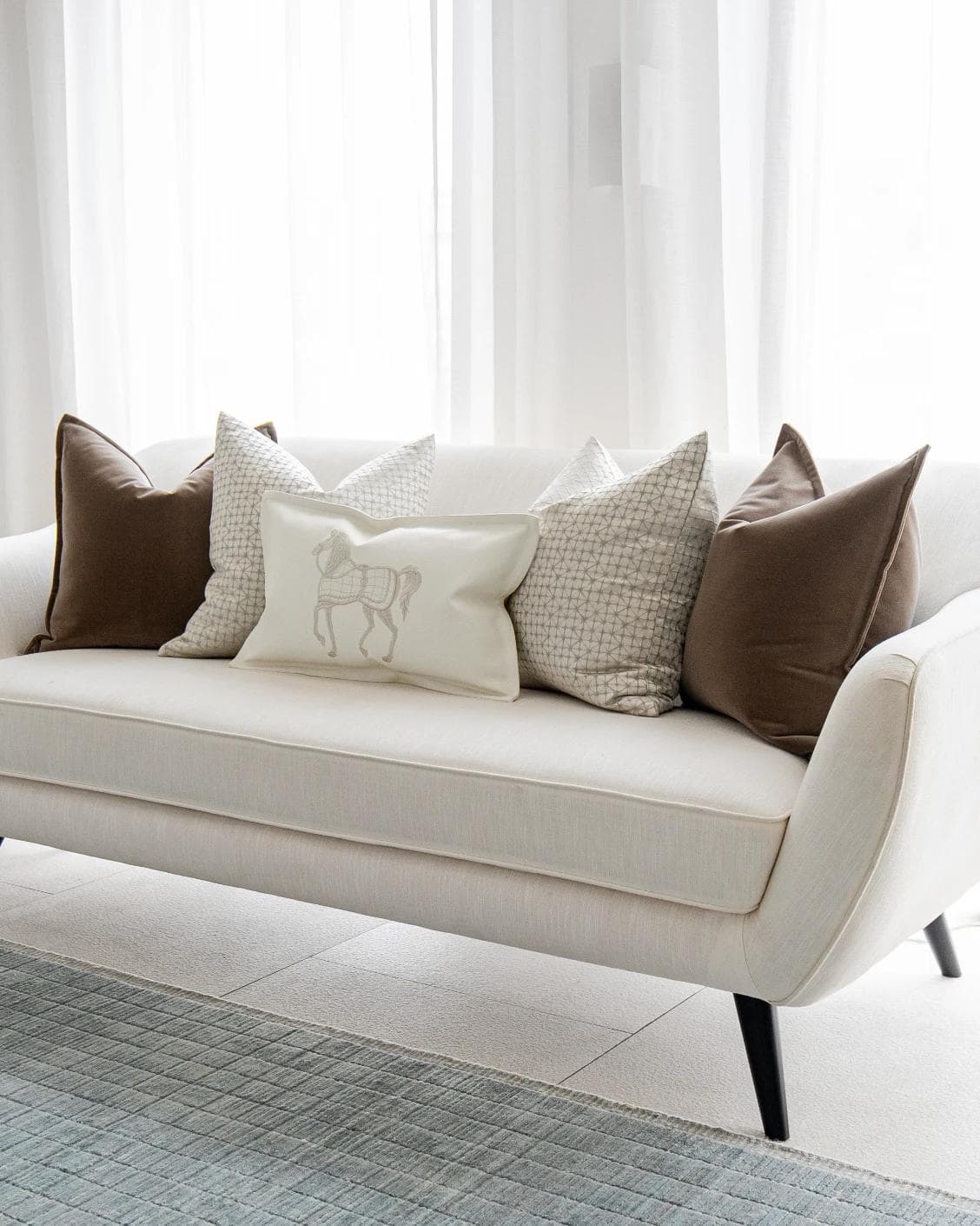 Lina Bundle cushion in brown, silver and white, shown in a lifestyle right view as image 2
