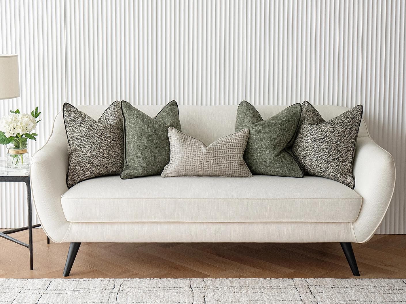 Constantine Bundle cushion in brown, shown in a lifestyle front view as image 2