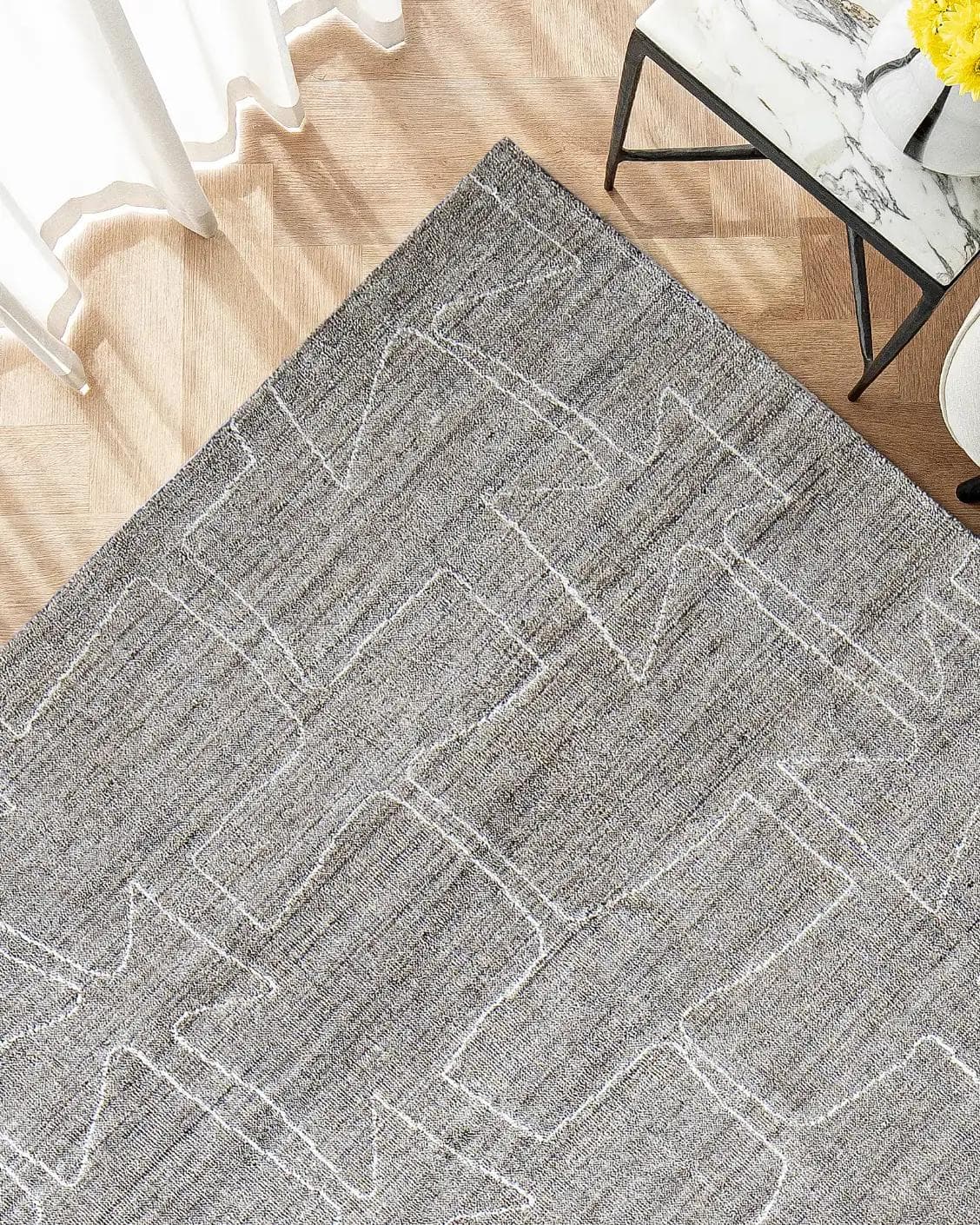 Caleb Dune carpet in grey and blue, shown in a lifestyle top view as image 2