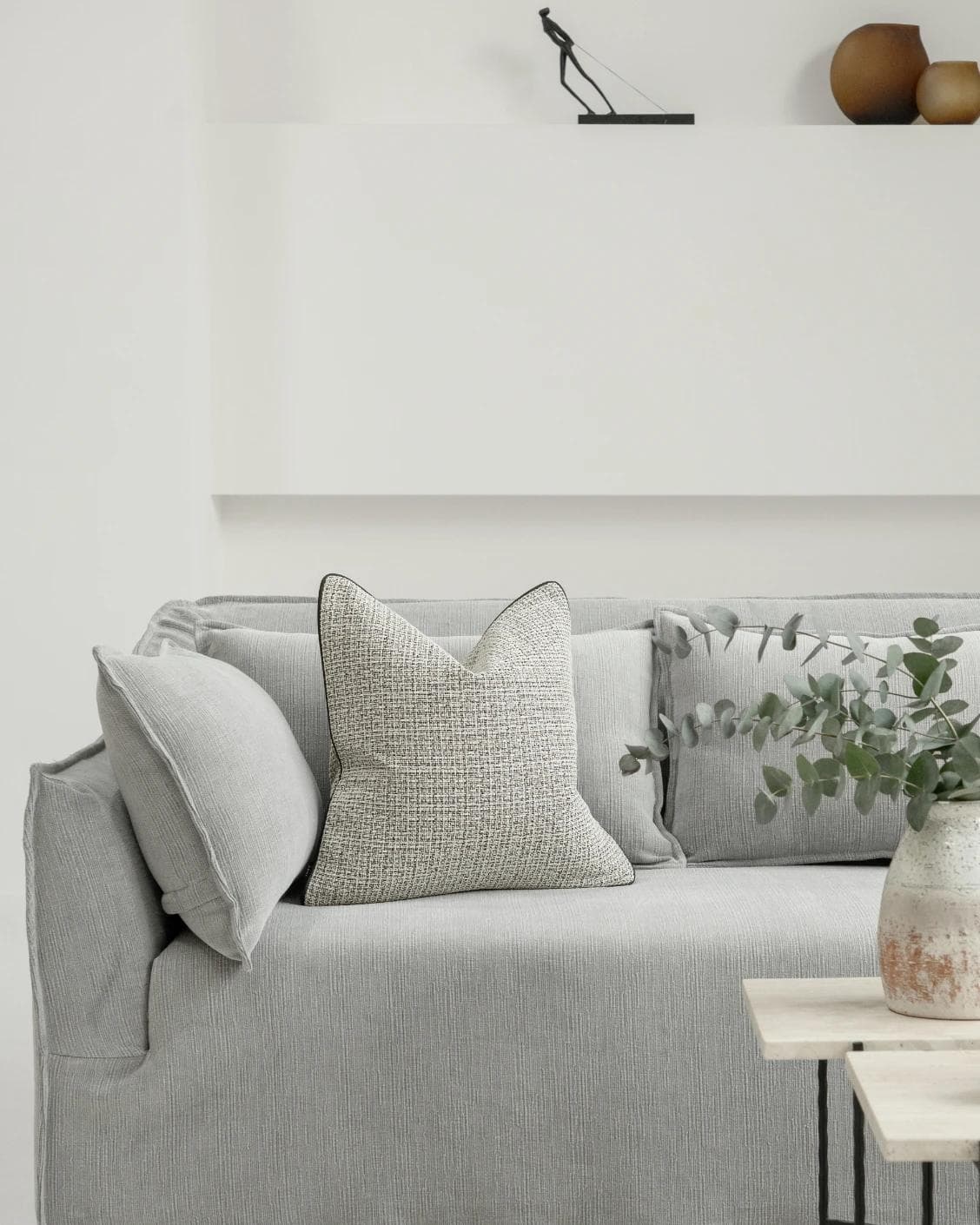 Cami Steele cushion in charcoal, shown in a lifestyle front view as image 4