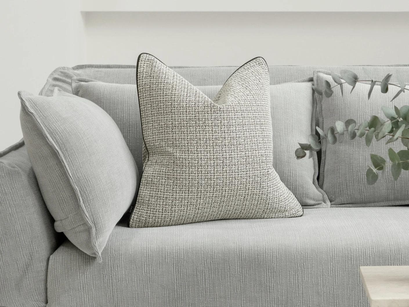 Cami Steele cushion in charcoal, shown in a lifestyle front view as image 4