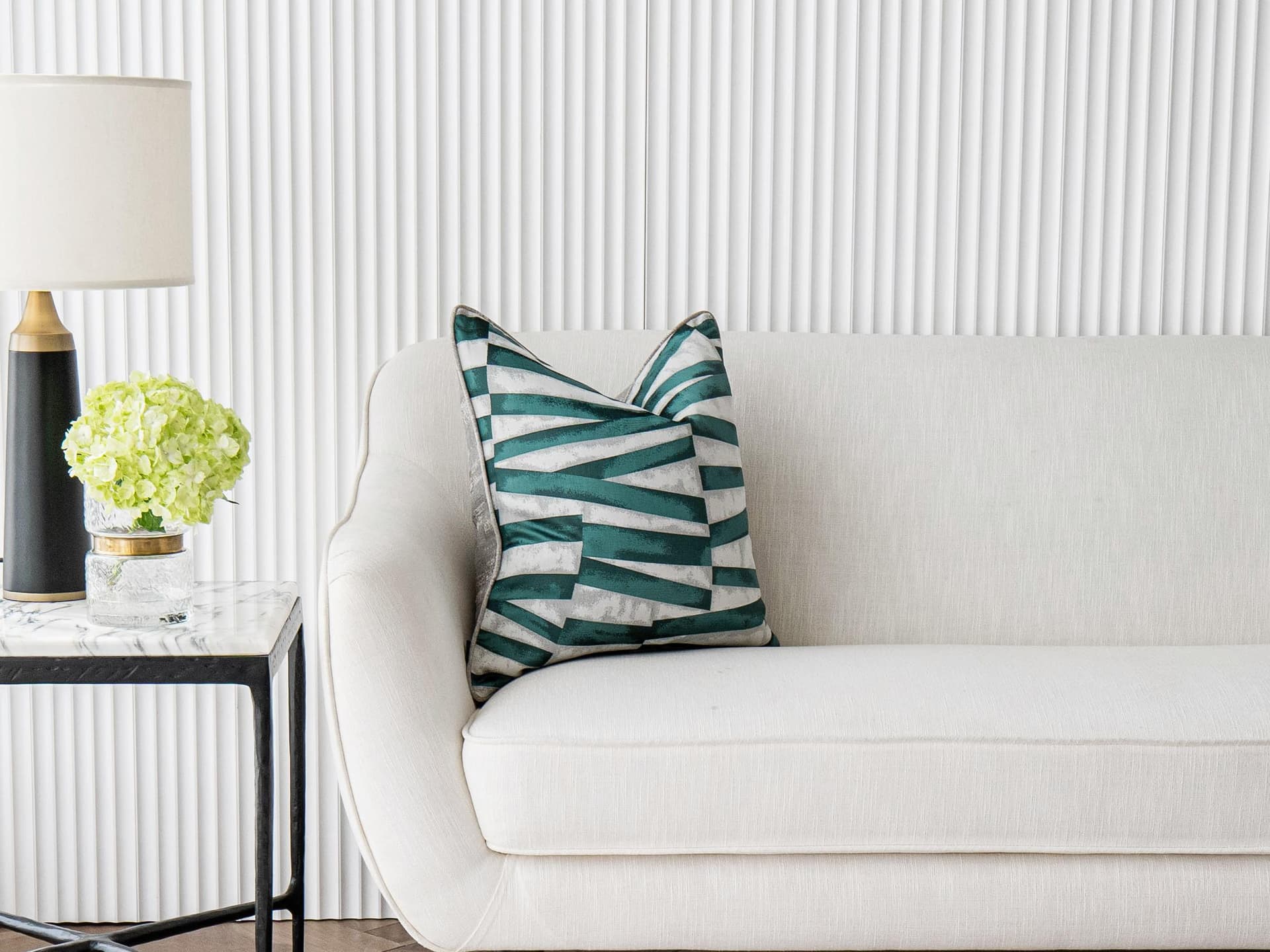 Carlie Teal cushion in turquoise, blue and green, shown in a lifestyle front view as image 1