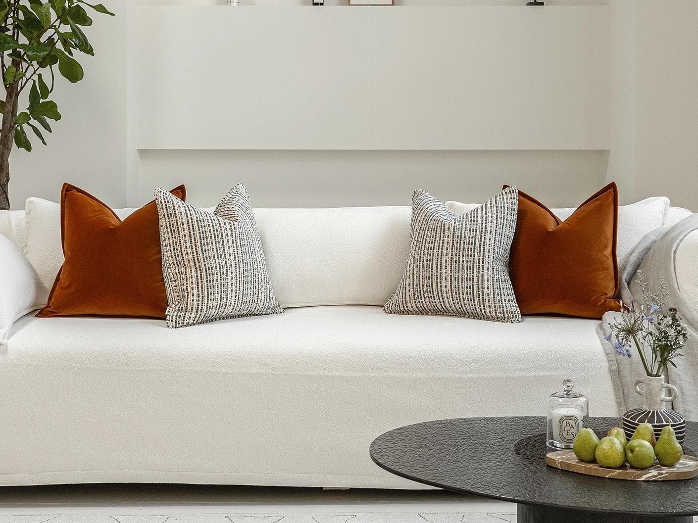 Cashwin Bundle cushion in cream and rust, shown in a lifestyle front view as image 4