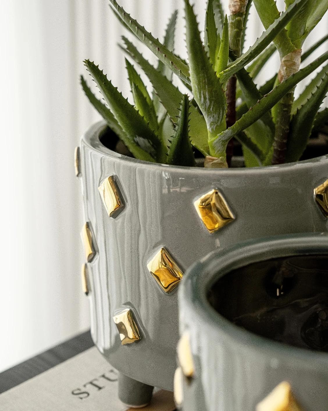 Caspian Arneson Bundle vases in grey and gold, shown in a lifestyle close-up as image 4