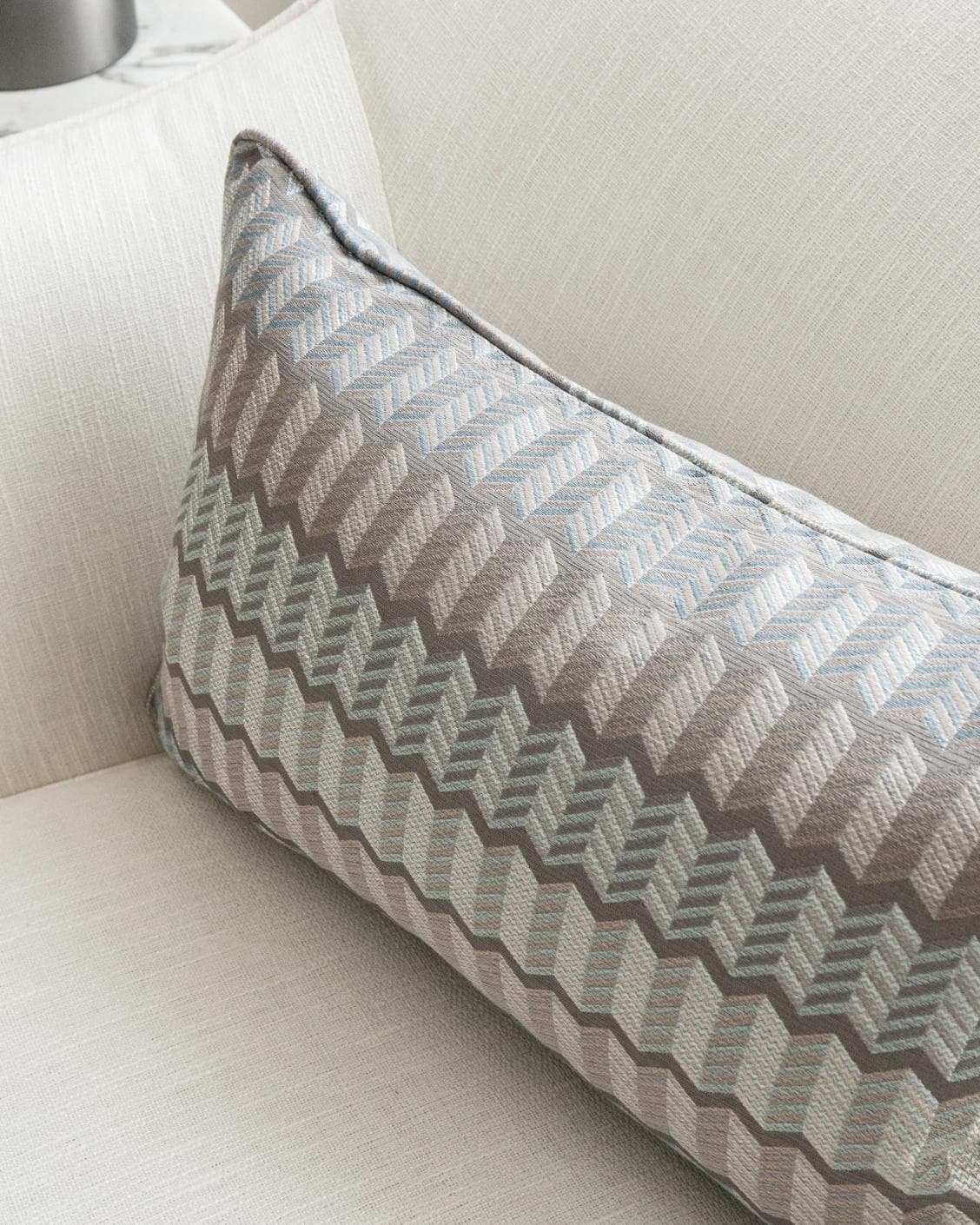 Cecilia Canova II cushion in silver, blue and multicolour, shown in a lifestyle top view as image 5