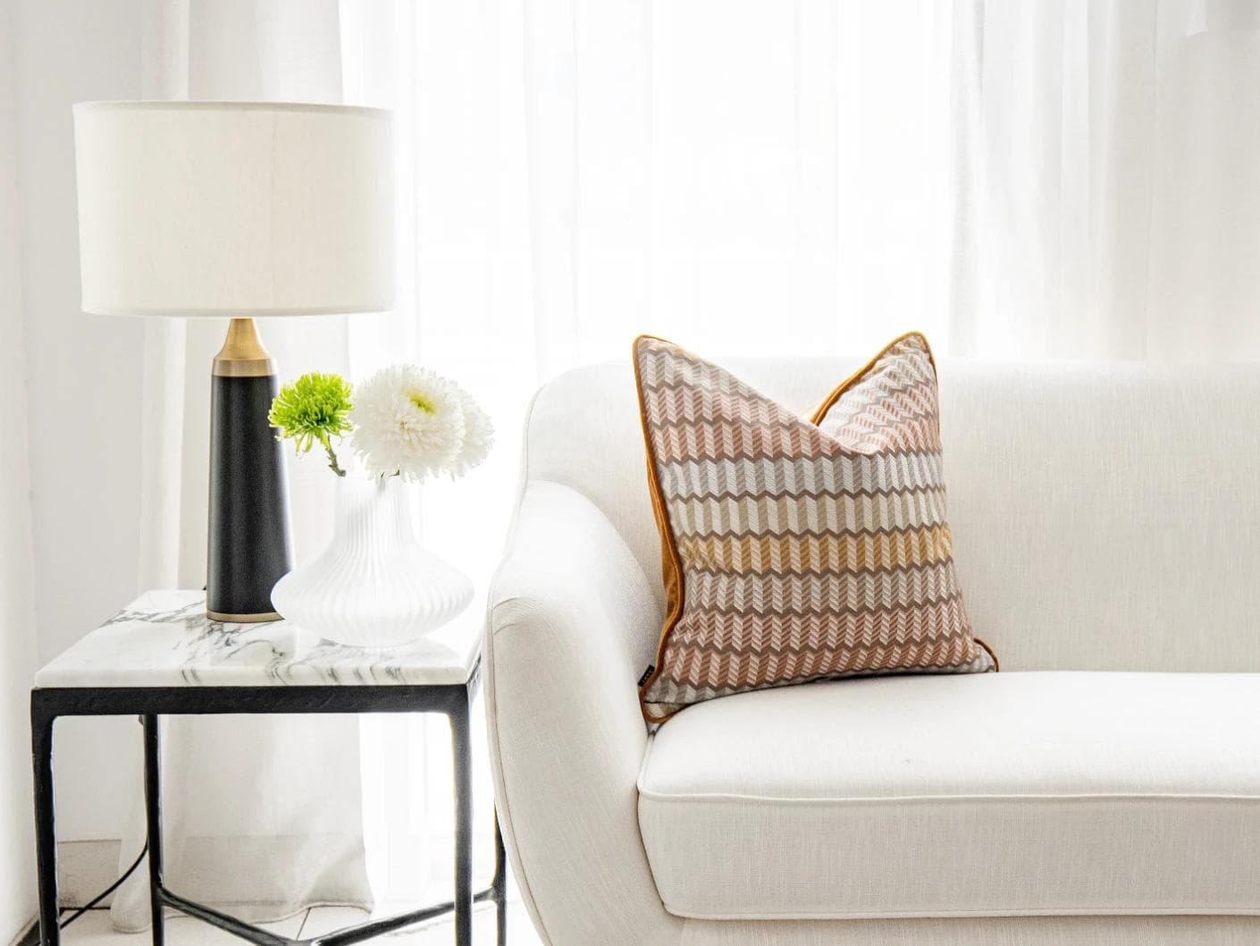 Cecilia Hodler cushion in orange, yellow and multicolour, shown in a lifestyle front view as image 4