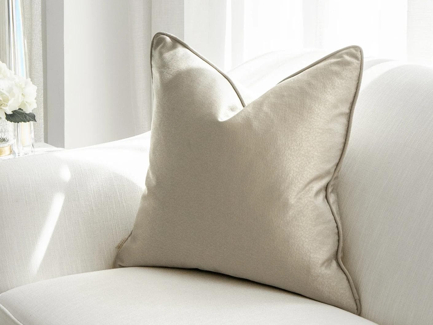 Celeste Laurent cushion in gold and beige, shown in a lifestyle front view as image 1